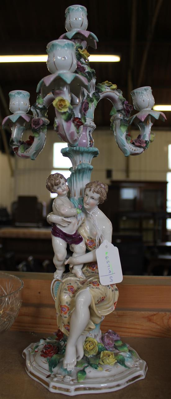 Continental porcelain figural four-branch candelabrum, with seated mother and child and flower encrustation